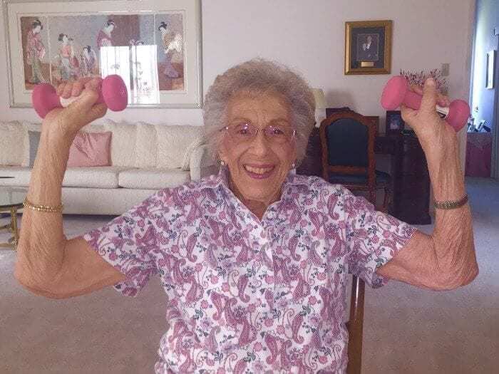 Elderly woman lifting weights