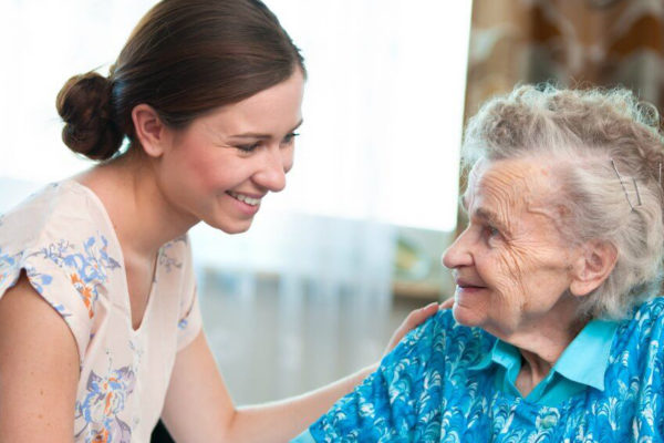 A woman taking care of an older person