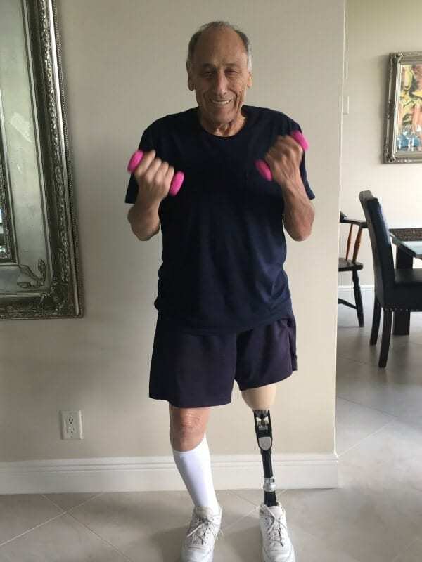 A man with a prosthetic leg lifting weights