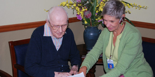 Caregiver reading a document for patient