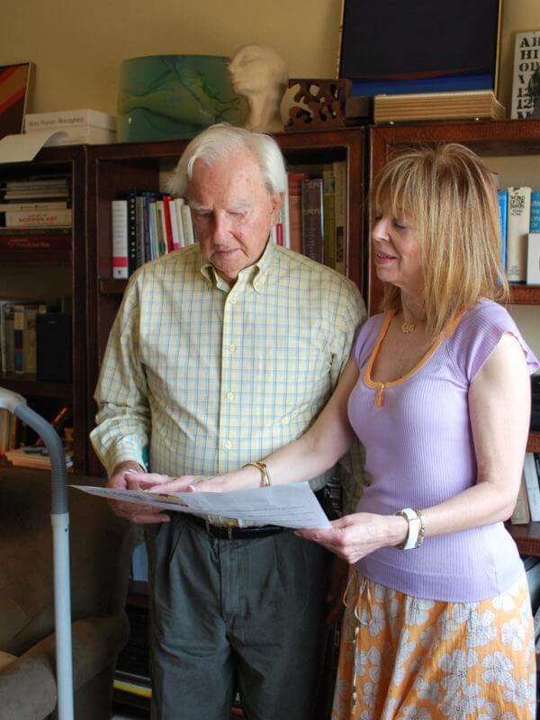 A woman and a man looking at a paper