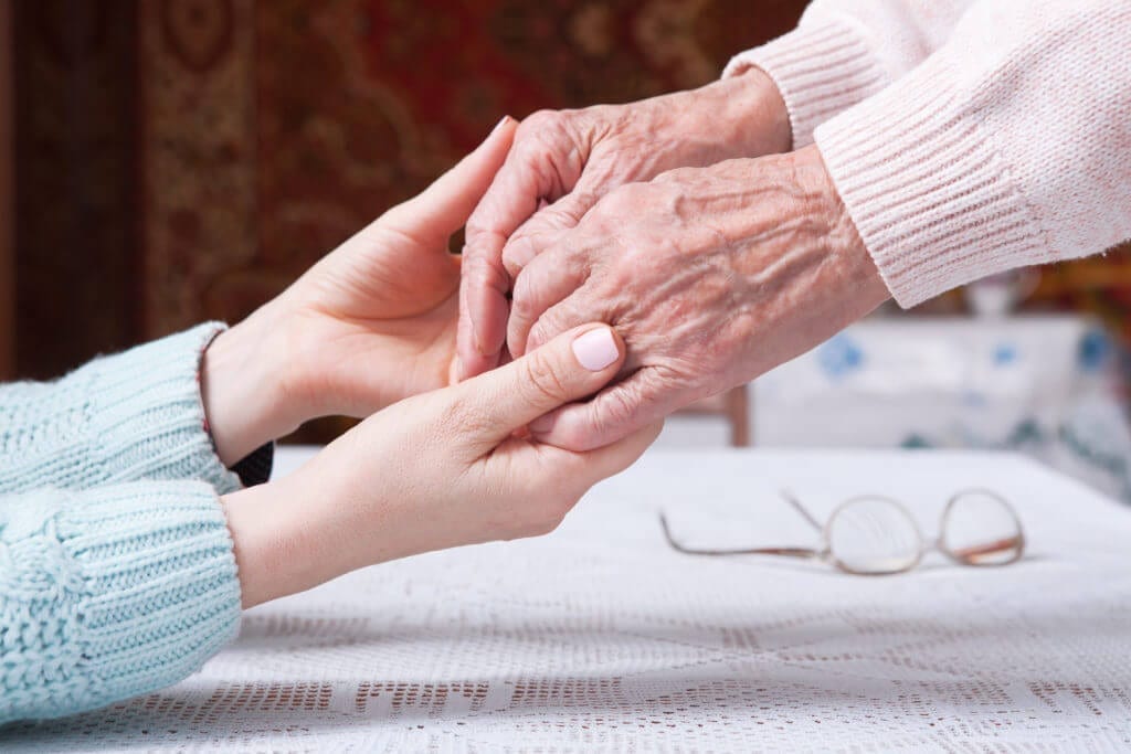 Two people holding hands