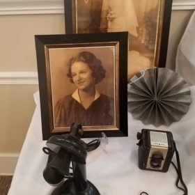 two pictures of woman and a telephone on table top