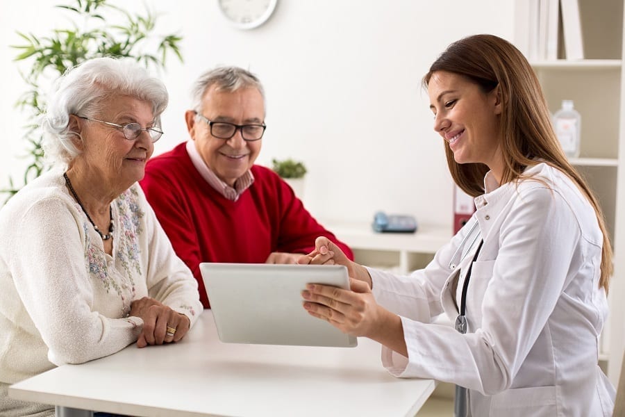 Woman explaining results to elderly couple