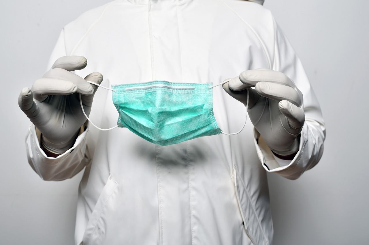 Medical professional holding a surgical mask