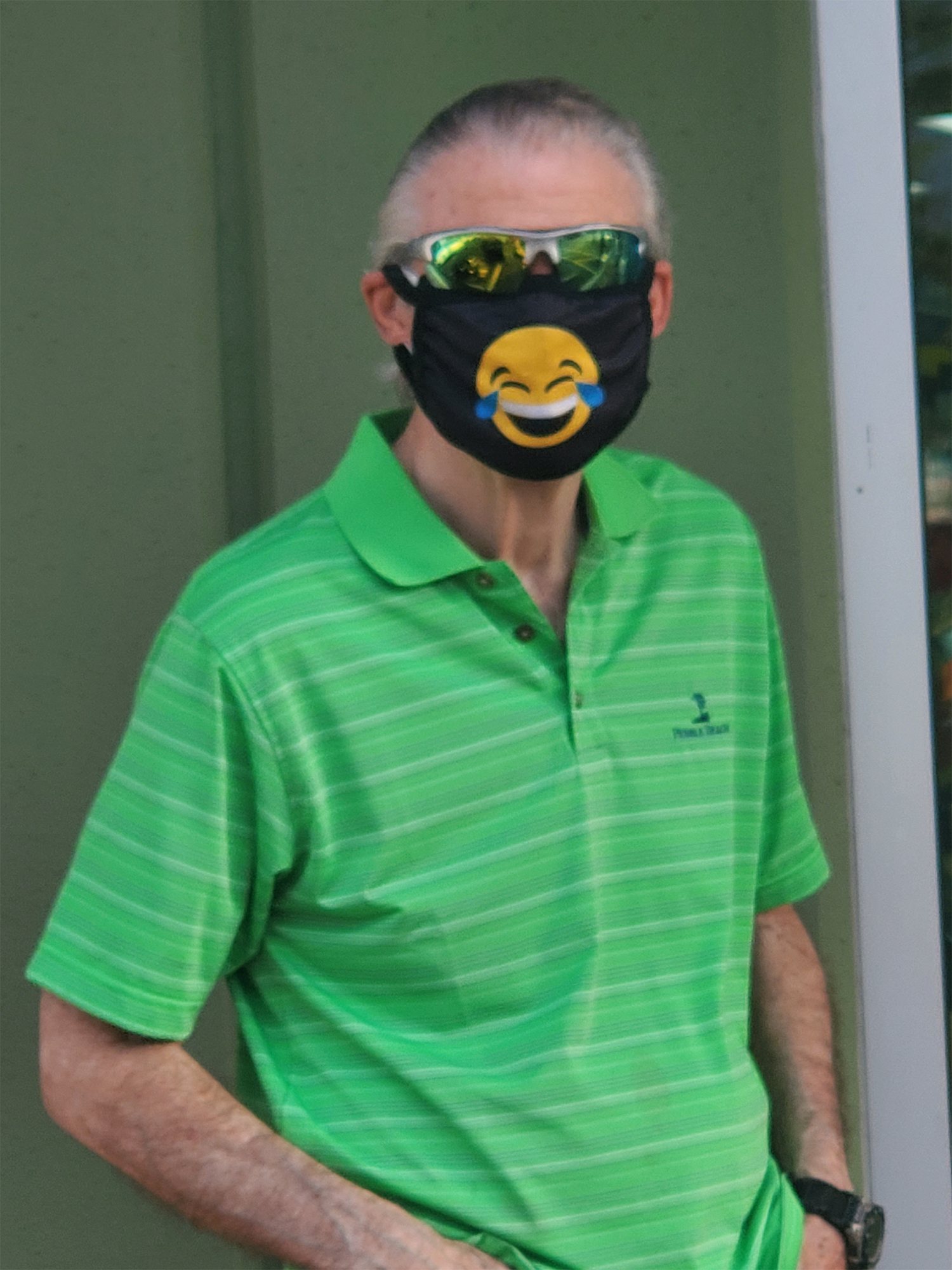 Older man with mask and green shirt